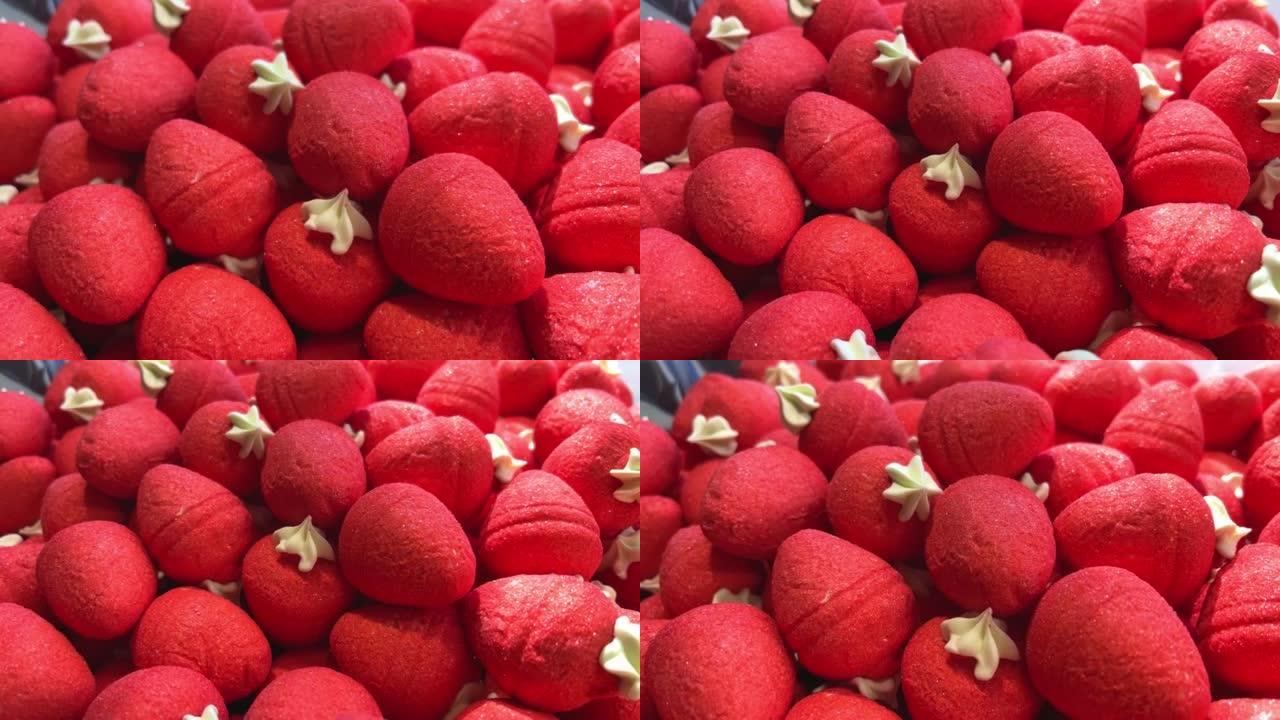 柜台上的草莓果冻糖果摆放着彩虹的所有颜色，就像唾液从果冻雕像流向意大利面和巧克力一样多