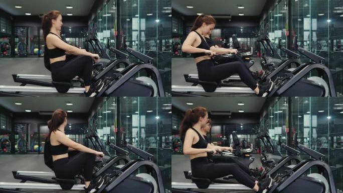 4k视频片段，一个美丽的年轻女子喜欢在健身房用划船机锻炼身体