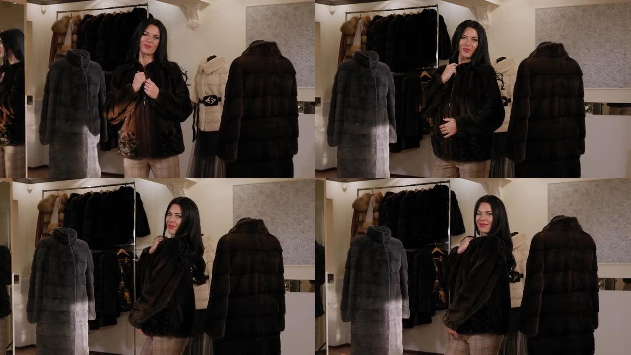 幸福的女人在购物中心的皮草店里选择一件新的皮草大衣。