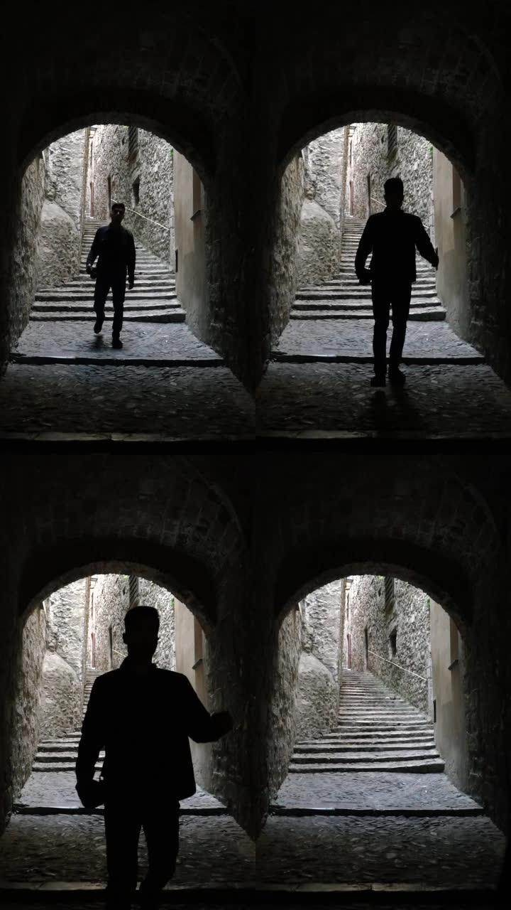 一名男子沿着狭窄的水泥小径走楼梯进入隧道