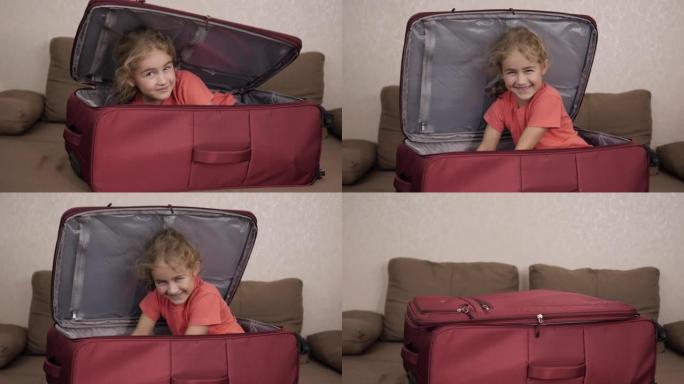 小孩在手提箱里玩。旅行车里的小孩。打包度假。快乐的儿童女孩游客从红色手提箱中寻找旅行度假冒险。孩子在