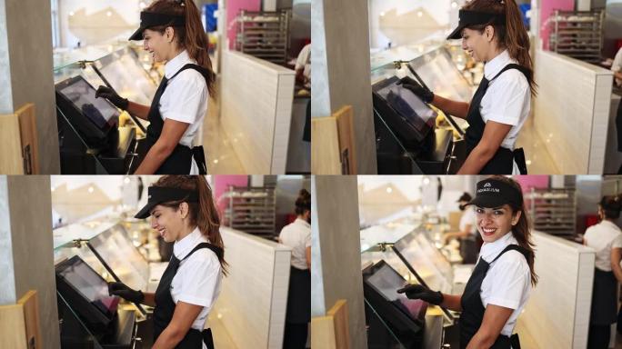 在快餐店工作的年轻美女