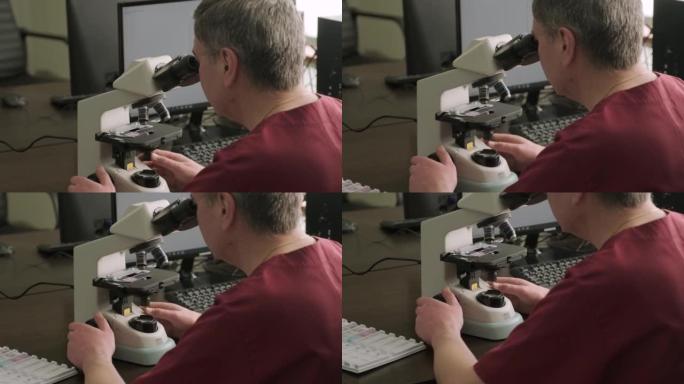 男性微生物学家，医务人员通过显微镜观察血液样本，并在实验室进行分析。实验室助理使用现代显微镜进行生物