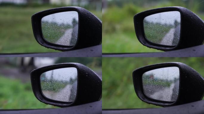 在雨天打开车窗看侧镜。