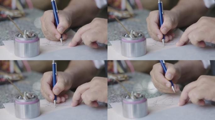 人类的手在纸上画画。