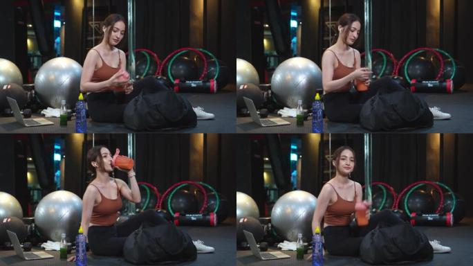 亚洲美女在健身房锻炼后制作，shanking和喝蛋白质奶昔，肌肉获得营养，健康