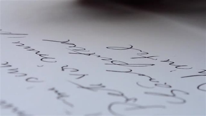 人用笔在一张白纸上写字