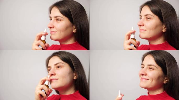 一名女性患者将喷雾剂推入鼻子以治疗鼻炎，这是一种呼吸困难的过敏