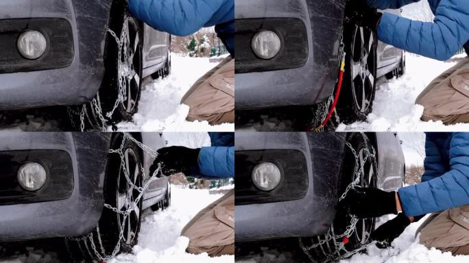 汽车被困在雪地里，男人在轮胎上放了防滑链