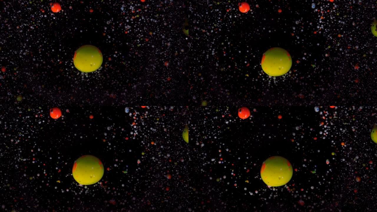 黑色背景上的圆形五彩球，银色亮片。白色、黄色和红色颗粒随机移动。