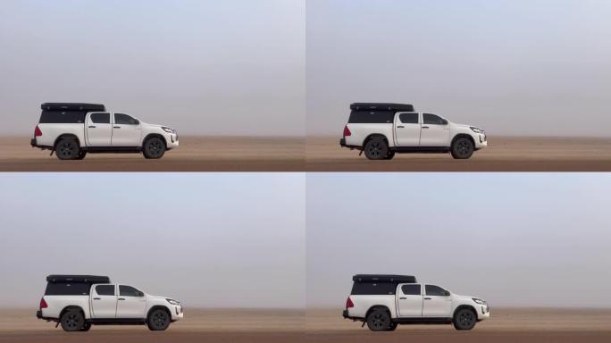 路边的汽车停在沙漠里。白色越野车越野汽车。晨雾