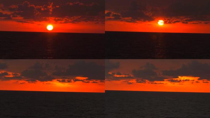 4k日出。神话般的形象。太阳通过红色的云层消失了。