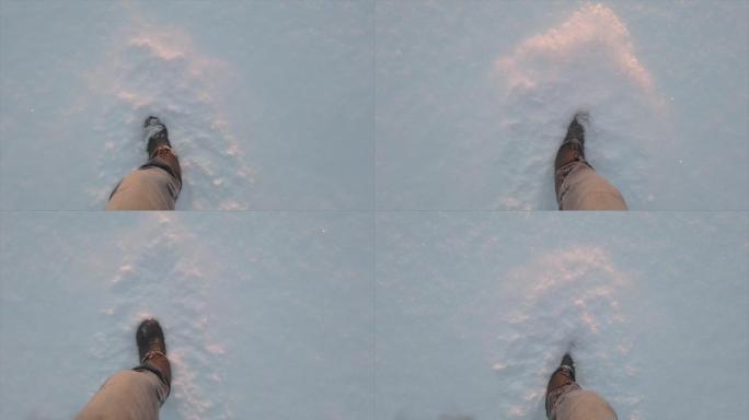 男人的腿在阳光下在雪地上行走。脚在深雪中行走。高质量全高清镜头。