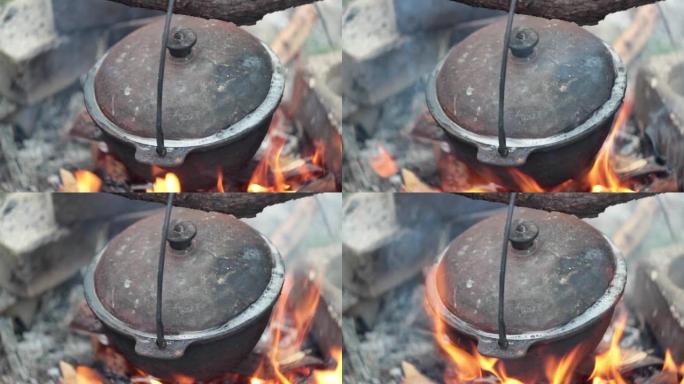 盖上盖子的大锅在火上沸腾