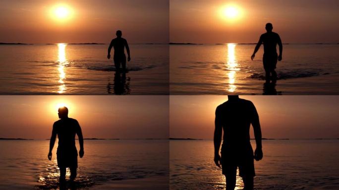 一个肌肉发达的人的轮廓在夕阳的光芒中从海里出来。度假、旅行、自由、健身