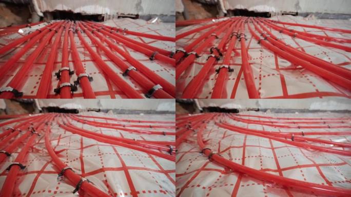 安装用于水加热的地板下加热管道。供暖系统。隔热地板用管道。