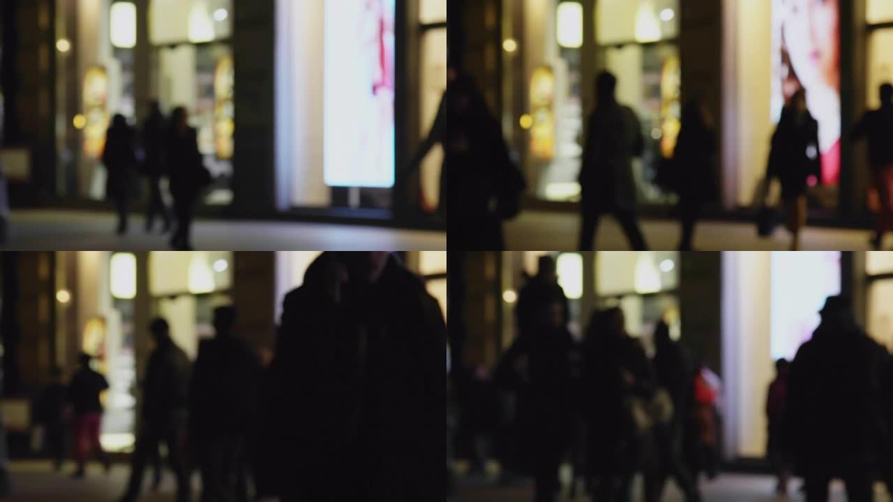 在市中心的steet夜生活中，商店门面bokeh的旅行者购物视线的抽象模糊运动镜头