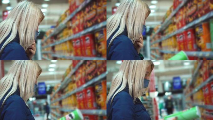 一个女人在超市里选择一袋薯片。在商店购物。