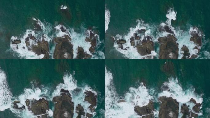 海浪撞击海洋中的岩石。一幅和平的自然画卷。水中岩石的鸟瞰图。海洋和陆地的交汇点。120 fps视频