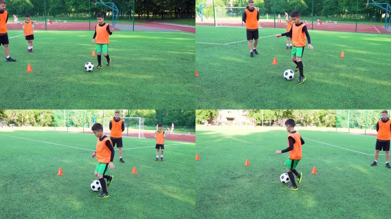 活跃自信的青少年男孩的特写镜头，他们在联合课上与足球教练一起训练在足球场上踢足球，4k