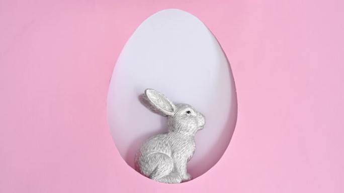 陶瓷银兔出现在蛋形框架中。复活节停止运动平躺