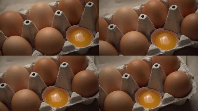 破碎的鸡蛋放在整个鸡蛋中的容器中