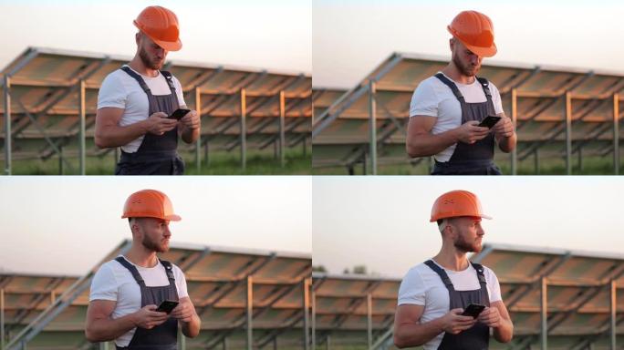 在太阳能农场使用智能手机的头盔工程师。