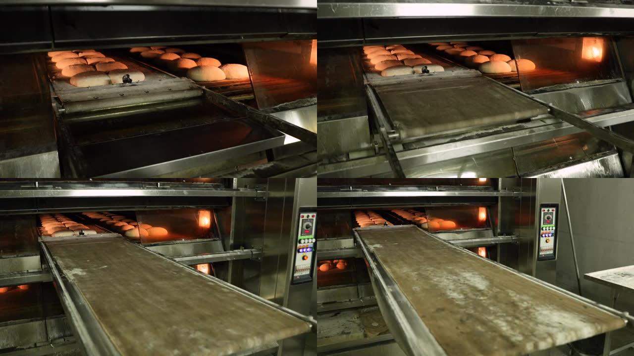 用羊皮纸卸下托盘，在电甲板烤箱中转移生面包面团-在面包店中制作面包