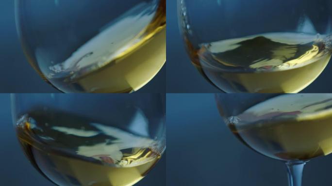 在散焦的深色背景上，在玻璃杯中挥舞金色白葡萄酒。美丽的葡萄酒广告素材。高脚杯内葡萄酒混合过程的特写视
