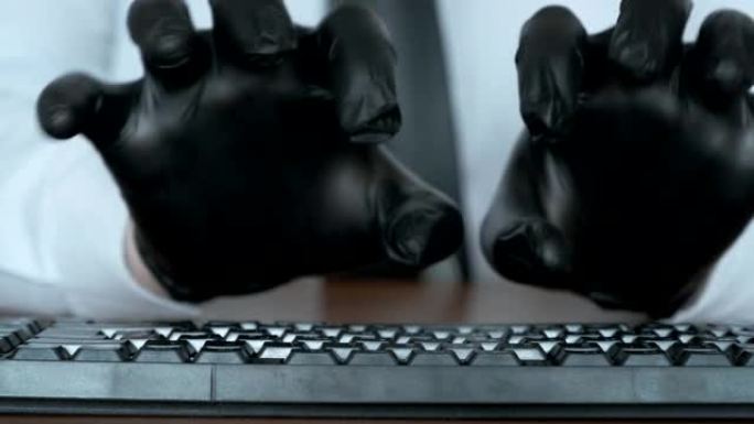 双手戴着黑色手套在键盘上打字。