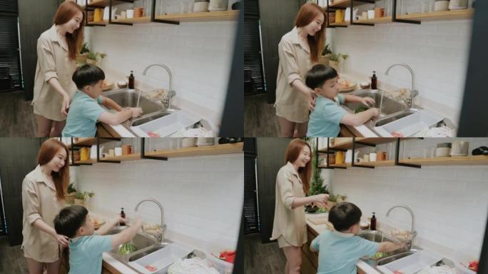 男孩想加入并帮助他的妈妈洗蔬菜，准备做晚餐。