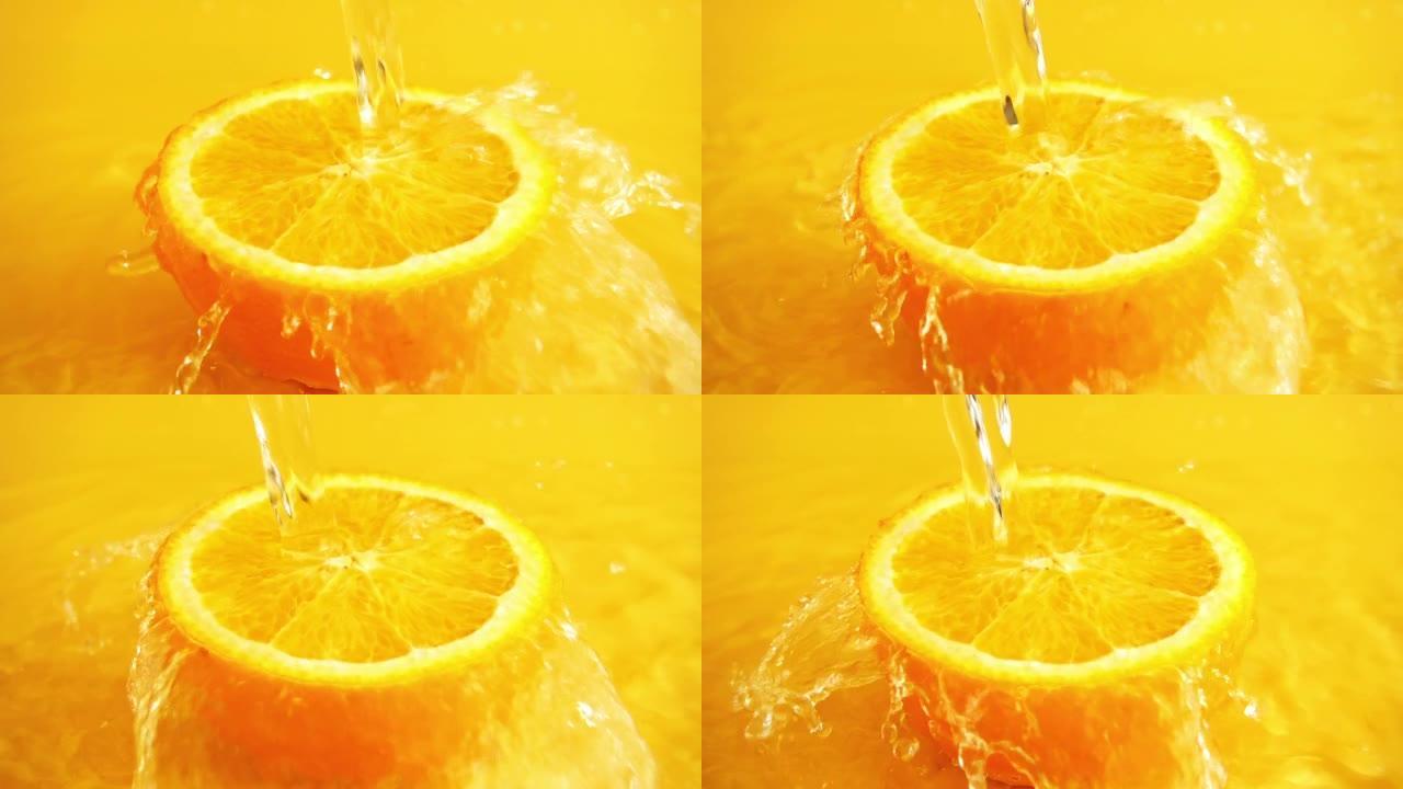 橙色背景上的水柱中的一半橙色。慢动作。