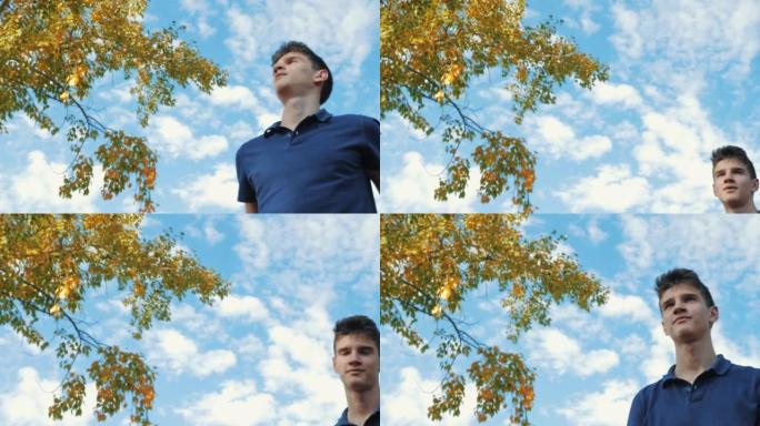 一个年轻的十几岁的男人在操场上把一个篮球扔进了戒指。