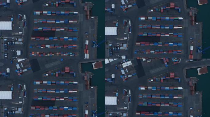 空中鸟瞰港口堆放集装箱的俯视图。排成各种颜色的集装箱，用于海外运输。物流、进出口概念