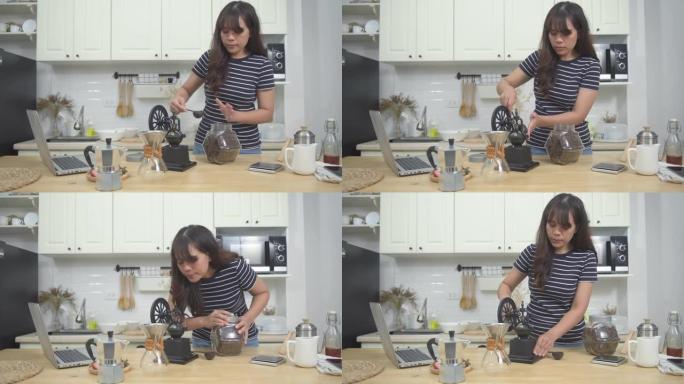 在家喝咖啡的概念，亚洲女人将咖啡豆从罐子里舀到手动研磨机，在家里玩得开心。