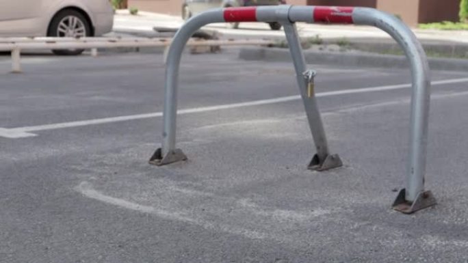 一个灰色停车锁。特写视频。预留停车位，可折叠障碍物。停车场安全屏障防止在这个地方停车