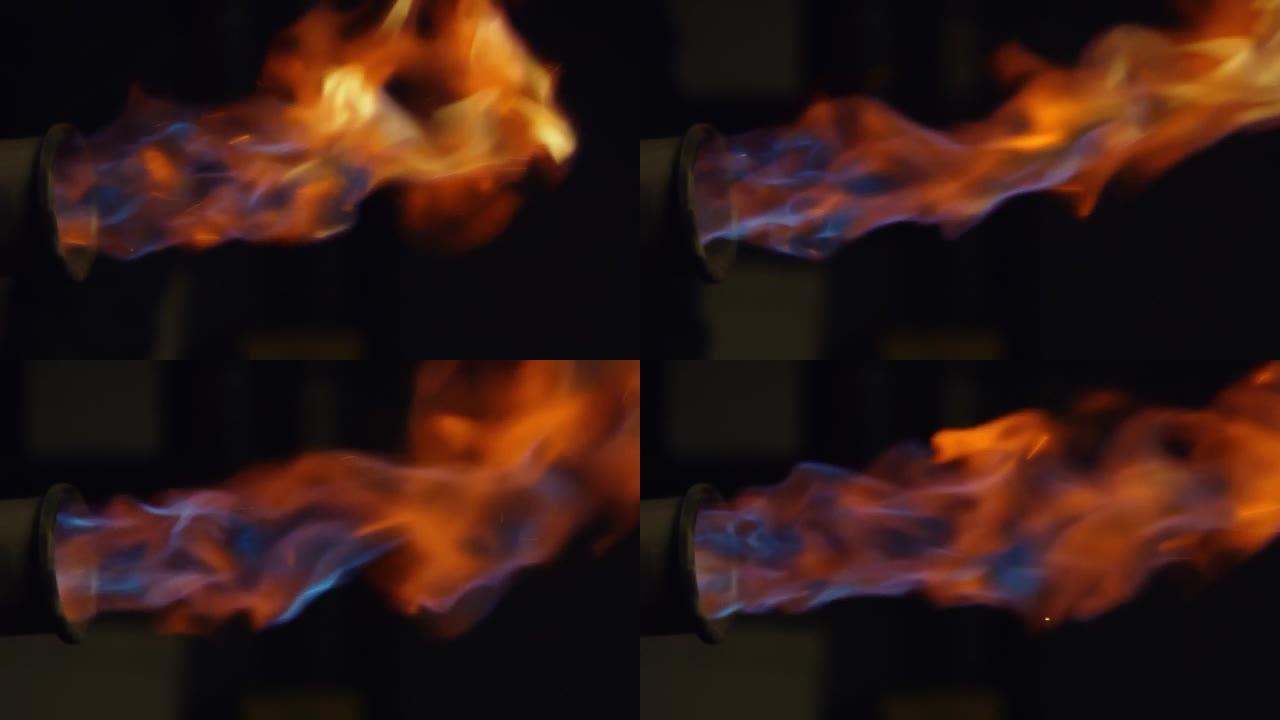 火焰隔离在黑色背景上。火球爆炸。慢动作中管道燃烧气体的火焰爆炸。特写。4k视频。在红色上射击