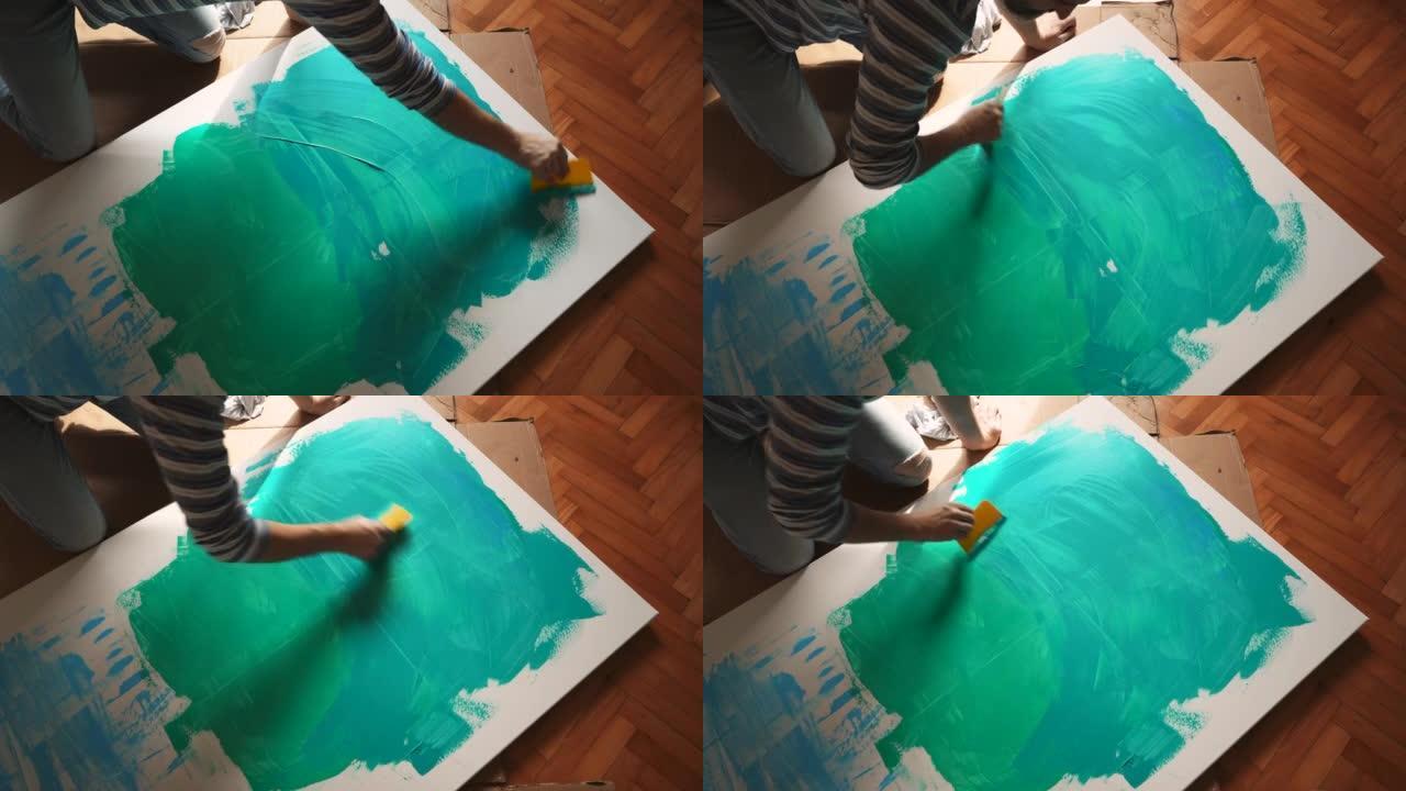 创造性高加索男性艺术家在画布上绘画的高角度视图