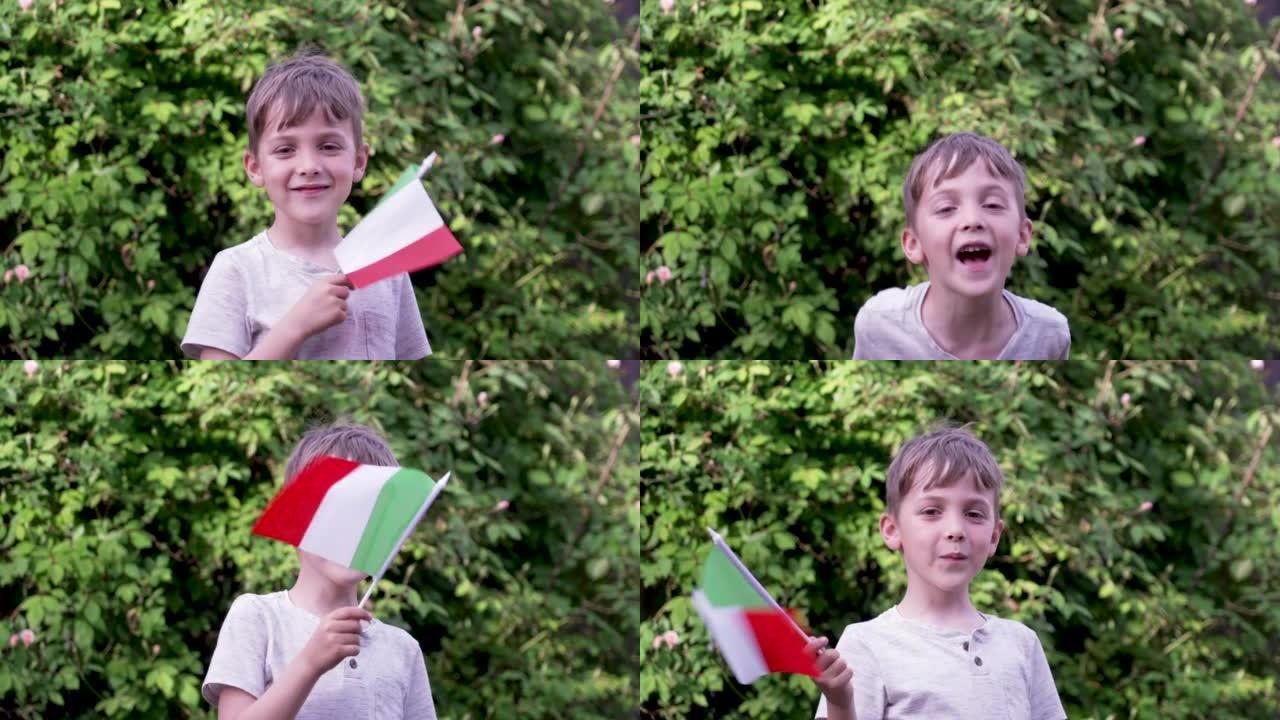 微笑的高加索男孩挥舞着意大利国旗看着相机