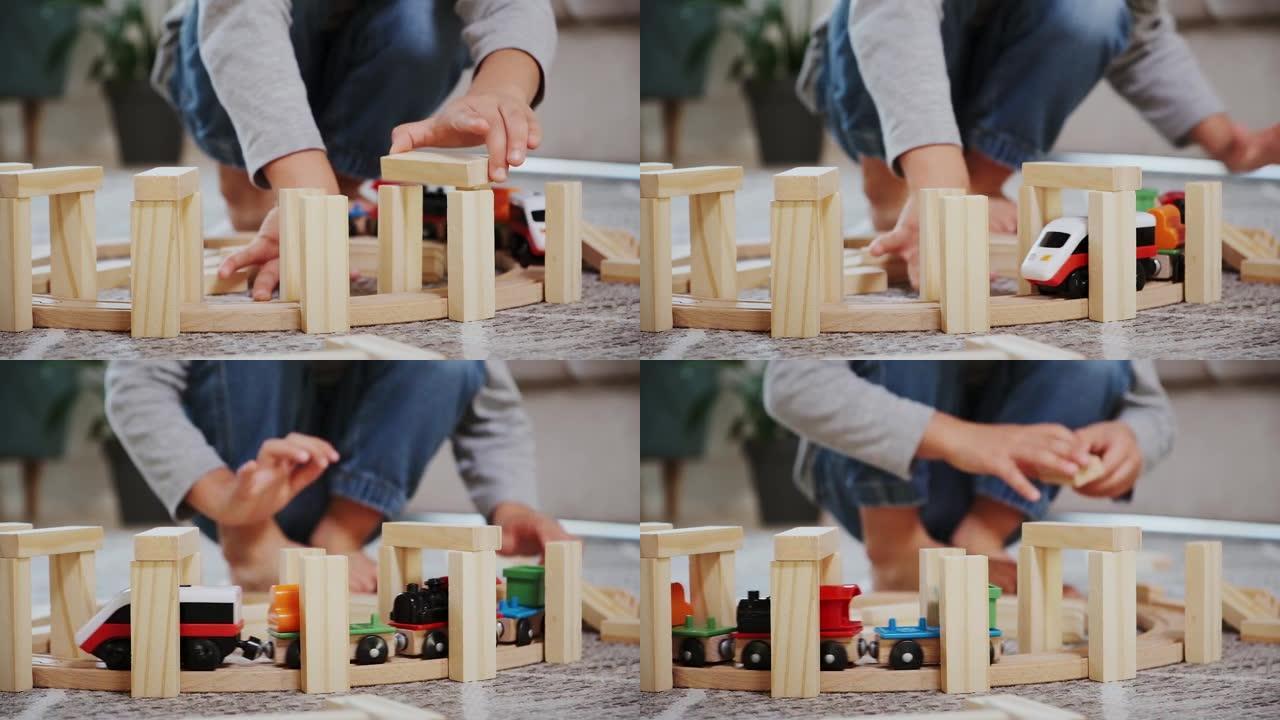 儿童游戏建造木制铁路，启动电子蒸汽机车坐在家里的地板上