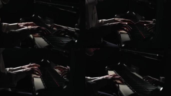 男性手在黑色背景的钢琴上演奏快速欢快的音乐。音乐家用手指触摸乐器的白色和黑色键，创造音乐旋律。特写。