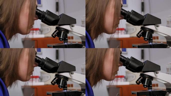一个穿着实验服的女人的特写镜头正准备开始显微镜研究