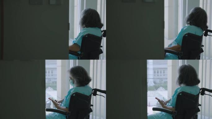 老年妇女坐在医院的轮椅上心不在焉，她感到孤独。