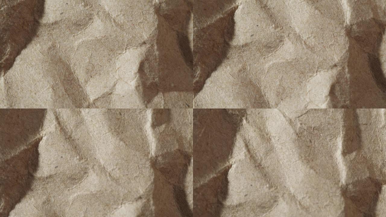 皱巴巴的工艺纸特写。回收棕色床单纹理，旧米色表面背景