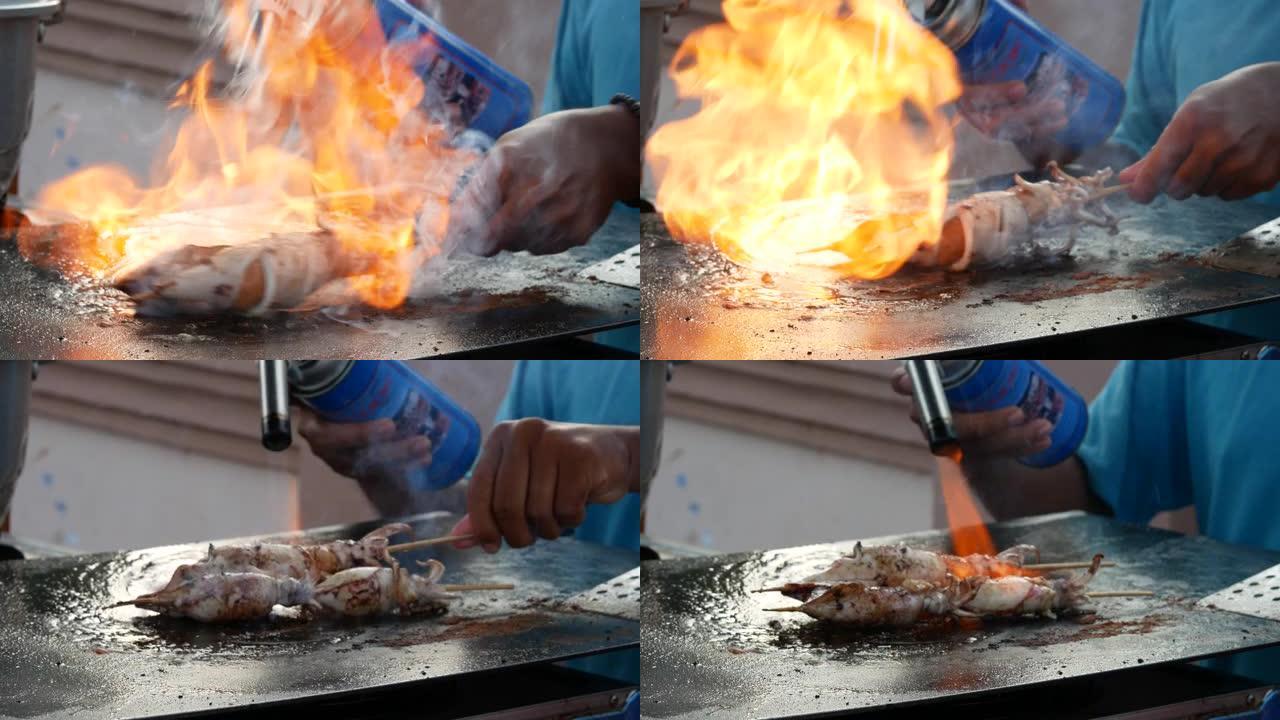 印尼街头食品销售商正在烹饪和烧烤章鱼或鱿鱼