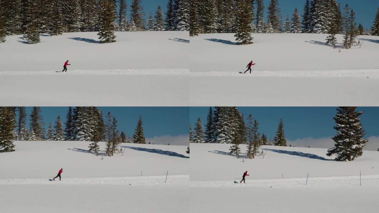在科罗拉多州阳光明媚的日子里，远距越野滑雪运动员以 “对角大步” 的方式在经过修饰的小径上进行远距越