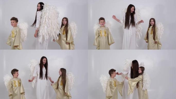 家庭妈妈和孩子们在白色背景上有天使之翼。情人节庆祝活动。