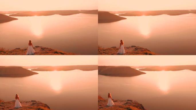 穿着白裙跳舞的新娘女人穿过岩石悬崖走向大海4k