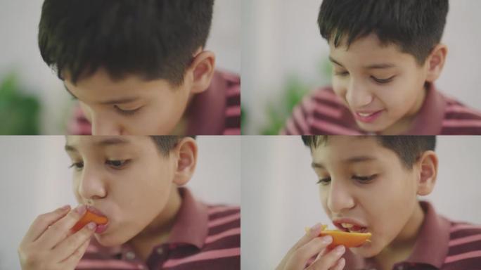 印度男孩吃他的橘子
