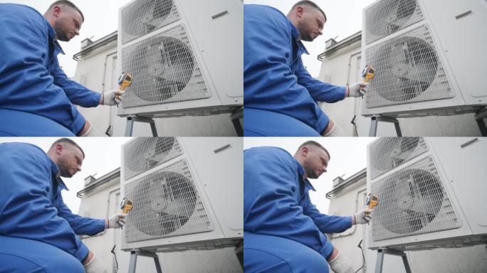 技术人员使用热成像红外温度计检查冷凝单元热交换器